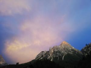 a mountain with a rainbow in the sky at Martins Apartmenthaus in Biberwier