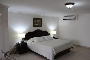 Cama ou camas em um quarto em Hotel Parador