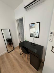 a black desk in a white room with a mirror at Room with private bath Santoniri inspired in Seattle