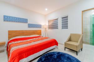 een slaapkamer met een bed, een stoel en een raam bij LOFT Lujoso y Moderno Con Cama King en Centrico Historico in Durango