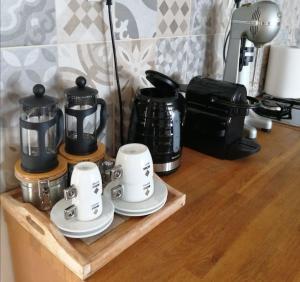 a wooden shelf with coffee pots and cups on it at Sea and Sun Luxury apartment in Neoi Epivates