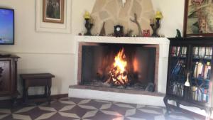 a fireplace with a fire in a living room at Casa Rural con encanto Señorio Manchego ALBACETE in Yeste