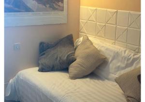 a bed with two pillows on top of it at Appartamenti Sud Ovest By MountainHouses in Sestriere