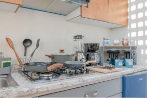 - un comptoir de cuisine avec 2 poêles sur une cuisinière dans l'établissement LOFT El Azul en Centro Historico con Cama King, à Durango