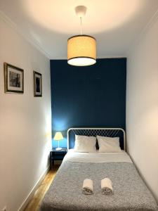 リスボンにあるCasa dos Mastrosの青い壁のベッドルーム1室