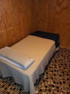 a small room with a bed and a stool at Harmony Tree Resorts inc in Nashville