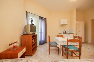 - un salon avec une table et une télévision dans l'établissement Beachfront apartments Jermen, à Sukošan