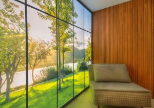 a chair in a room with a large window at Livin'Milano PRESTIGE in Milan