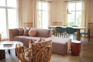 a living room with a couch and a table at The Ryder Hotel in Charleston