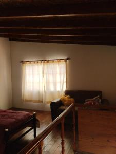 a living room with a couch and a window at Alojamiento turístico NFG in San Carlos de Bariloche