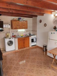 a kitchen with a washing machine and a refrigerator at Alojamiento turístico NFG in San Carlos de Bariloche