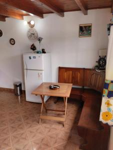 a kitchen with a small table and a refrigerator at Alojamiento turístico NFG in San Carlos de Bariloche