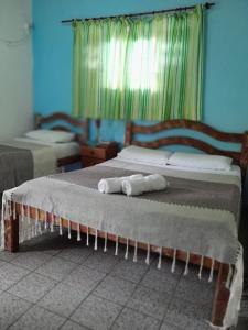 Ένα ή περισσότερα κρεβάτια σε δωμάτιο στο Casa Vida Doce