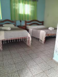A bed or beds in a room at Casa Vida Doce