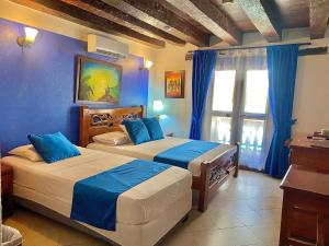 Voodi või voodid majutusasutuse Hotel Don Pedro De Heredia toas