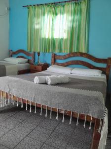 A bed or beds in a room at Casa Vida Doce