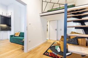 a living room with a green couch and a loft at Elegant Stay Near Hungarian Museum by Pink Flamingo in Budapest