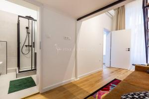 a bathroom with a shower and a walk in closet at Elegant Stay Near Hungarian Museum by Pink Flamingo in Budapest