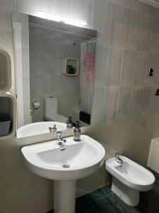 a bathroom with a sink and a mirror and a tub at El rincón exquisito in Albacete +10 photos