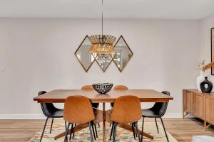 a dining room table with chairs and a chandelier at Downtown Condo Walk To Mercedes Benz Stadium in Atlanta