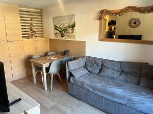 アロスにあるLa foux d allos Superbe appartement 6 couchages ,piscineのソファとテーブルのあるリビングルーム