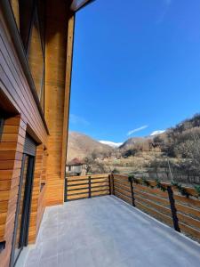 a balcony of a house with a view of the mountains at KoCHALET Apartment in Crni Vrh