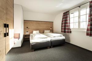 Rúm í herbergi á Hotel-Gasthof Löwen