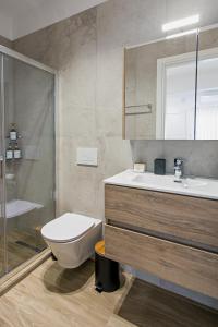 a bathroom with a toilet and a sink and a shower at Airbnb Kastoria - Bella Vista A in Kastoria