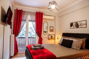 a bedroom with red curtains and a large window at “Contessina Athens Suite #731” in Athens