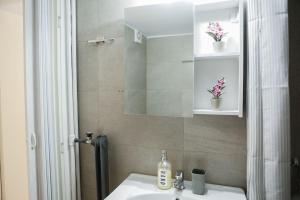 a bathroom with a sink and a mirror at “Contessina Athens Suite #731” in Athens