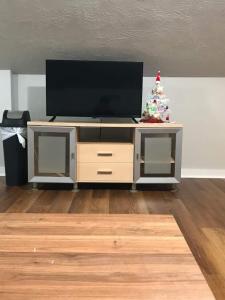 a entertainment center with a television and a christmas tree at Clinton Studio in Lafayette