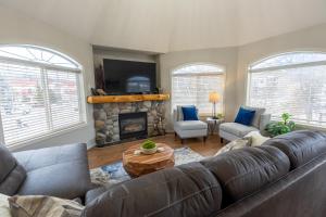 a living room with a couch and a fireplace at Riverside Condos by Fernie Central Reservations in Fernie