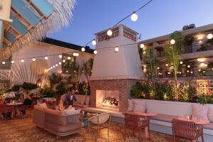 a restaurant with a fireplace and tables and chairs at The Ryder Hotel in Charleston