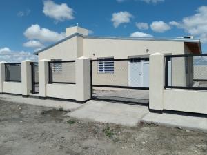 a white house with a gate in front of it at Km 9 in Viedma