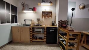a kitchen with a black refrigerator and a counter at Sunset View 1-2 by Madriguera in La Libertad