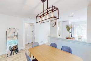 a dining room with a table and a clock on the wall at Bay Acres Bungalow in Osprey