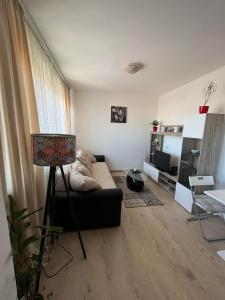 a living room with a couch and a table at Apartman LALA - Beograd, Surčin in Surčin