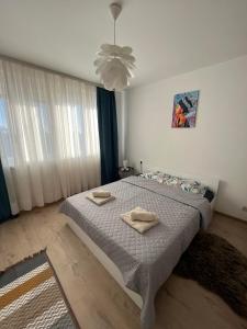 a bedroom with a bed with two towels on it at Apartman LALA - Beograd, Surčin in Surčin