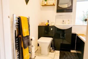 a bathroom with a white toilet and a sink at Elite 49 Stays in Newcastle upon Tyne