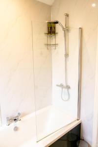 a glass shower in a bathroom with a sink at Elite 49 Stays in Newcastle upon Tyne