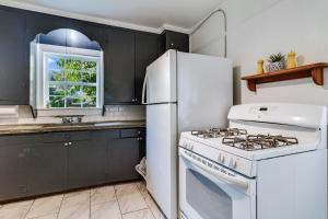 a kitchen with a white stove and a white refrigerator at Jefferson Flat in Lafayette