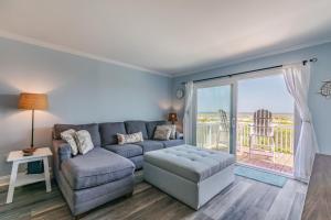 a living room with a couch and a chair at Ocean Front D-Building - POOL ACCESS AND OCEAN VIEWS!!! in Harbor Island