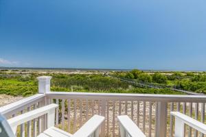 a view of the beach from the balcony of a house at Ocean Front D-Building - POOL ACCESS AND OCEAN VIEWS!!! in Harbor Island
