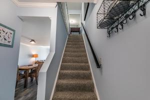 a staircase leading up to a dining room with a table at Ocean Front D-Building - POOL ACCESS AND OCEAN VIEWS!!! in Harbor Island