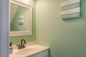 a bathroom with a sink and a mirror at Ocean Front D-Building - POOL ACCESS AND OCEAN VIEWS!!! in Harbor Island