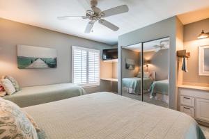 a bedroom with a bed and a mirror at Ocean Front D-Building - POOL ACCESS AND OCEAN VIEWS!!! in Harbor Island