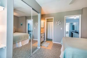 a bedroom with two beds and a mirror at Ocean Front D-Building - POOL ACCESS AND OCEAN VIEWS!!! in Harbor Island