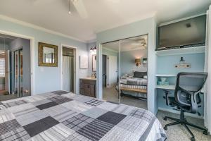 a bedroom with a bed and a desk and a chair at Ocean Front D-Building - POOL ACCESS AND OCEAN VIEWS!!! in Harbor Island