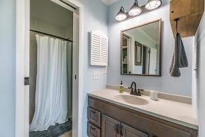 a bathroom with a sink and a mirror at Ocean Front D-Building - POOL ACCESS AND OCEAN VIEWS!!! in Harbor Island