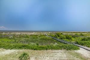 a boardwalk in the middle of a beach at Ocean Front D-Building - POOL ACCESS AND OCEAN VIEWS!!! in Harbor Island